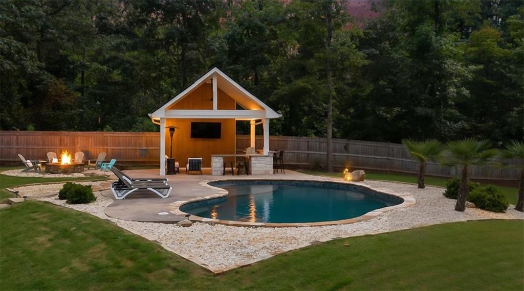 Welcome to Your Roswell Retreat! Tucked away on nearly an acre in the heart of Roswell, 1365 Ridgefield Drive isn’t just a house—it’s a lifestyle. This 3-bedroom, 2-bath ranch blends charming farmhouse style with thoughtful updates, creating a home that feels both welcoming and comfortable.
Inside, you’ll find an open living room anchored by a cozy brick fireplace, complete with a built-in wet bar offering the perfect place to unwind. Warm hardwood floors flow throughout the home - with no carpet in sight.The renovated gourmet kitchen features quartz countertops, a breakfast bar with a dramatic waterfall edge, and stainless steel appliances. The primary suite is a calming escape featuring a spa-inspired Roman shower, dual vanities, and a custom walk-in closet designed to keep everything in its place.
But the heart of this home may just be outdoors. Step outside and discover a true backyard oasis. A massive fenced yard invites pets and kids to play freely, while the PebbleTec saltwater pool promises endless summer fun. As the seasons change, gather around the outdoor fire pit on crisp fall evenings, or host friends under the custom pergola with built-in grill—perfect for Sunday football and casual cookouts.
All of this is nestled with in the highly sought-after North Point subdivision, just five minutes from Downtown Roswell and Canton Street—where vibrant restaurants, shops, and community events like Alive in Roswell bring the town to life. Outdoor lovers will also appreciate being a short drive to Azalea Park and the Chattahoochee River for hiking, kayaking, and weekends in nature.
If you’ve been searching for a home that combines comfort, character, and a resort-style backyard, this Roswell gem has it all!
