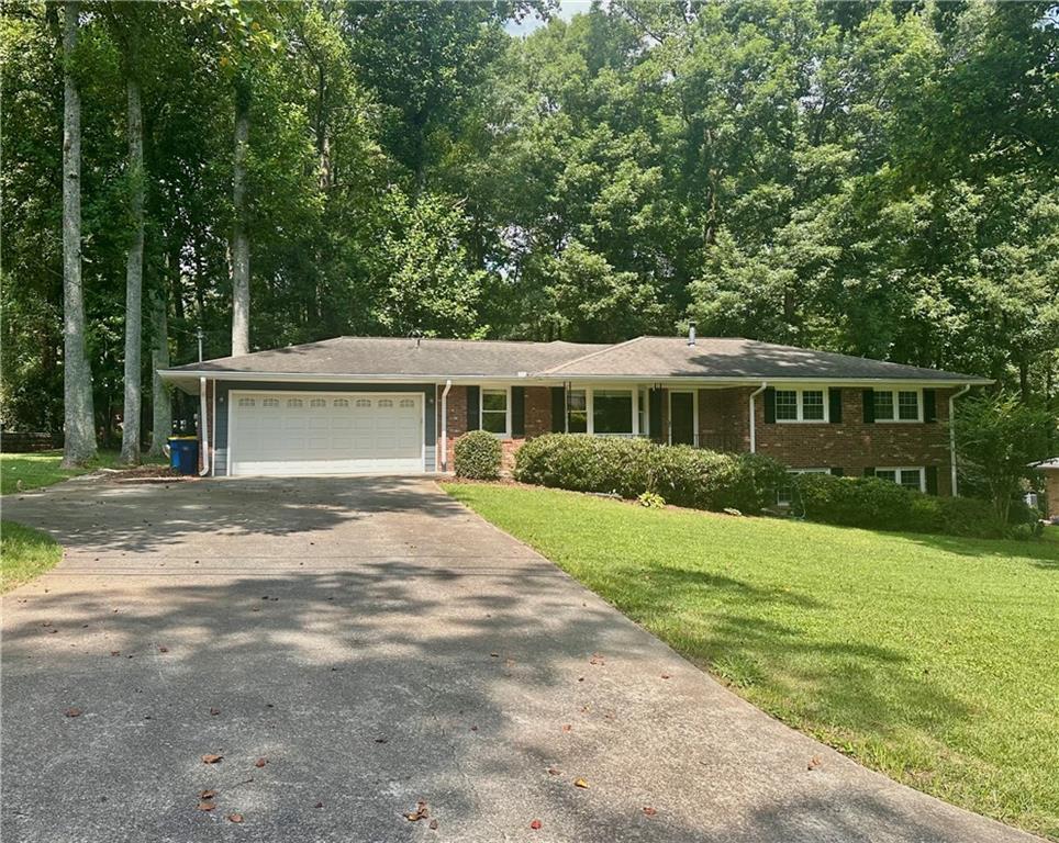 Stunning Renovated Ranch with Finished Terrace Level in the Heart of Kennesaw! Welcome home to this beautifully updated open-concept ranch, perfectly situated within walking distance to Downtown Kennesaw, Depot Park, local shops, and delicious BBQ! Step inside to find gleaming refinished hardwoods and a bright, airy layout. The completely remodeled kitchen is a showstopper -- featuring new white cabinetry, granite countertops, a stylish backsplash, newer stainless steel appliances, and a long breakfast bar that opens to a spacious living room with bay window (perfect as a flex space) and a large dining area. The oversized great room offers warmth and charm with a cozy fireplace flanked by custom built-ins. All three main-level bedrooms feature hardwood floors and share two fully renovated bathrooms. The terrace level is brand new and spectacular! Enjoy smooth ceilings, two additional bedrooms, a beautifully upgraded full bath, and a huge media/rec room wired for surround sound with soundproof ceilings -- ideal for movie nights or entertaining. Additional features include: Newer HVAC & water heater * Upgraded plumbing and electrical systems * Enclosed carport converted into a garage. Massive out-building with electricity and water -- perfect for a workshop, studio, or storage. This one has it all -- style, space, and an unbeatable location!