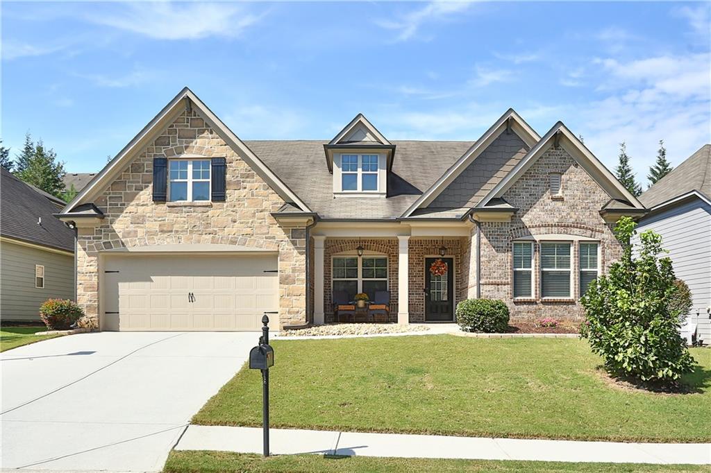 Impeccably maintained and rare to find ranch style home in the ever-popular Riverbend at Mulberry neighborhood. On arrival, you will be greeted by a welcoming front porch and exceptional curb appeal. Upon entry, gleaming wood floors and a deceivingly expansive floor plan are sure to delight. Off the foyer is flex space, currently used as an office and a half bath for guests. The open concept kitchen is an entertainer's dream with a massive island and dining area that overlooks the great room and office nook. Coffered ceilings, impressive molding detail and fireplace punctuate the space. The split bedroom plan features two secondary bedrooms with a full bath on one side of the main floor. Prepare to be amazed by the primary suite with luxurious spa-like bath, custom tile work and oversized shower with dual showerheads. Beyond the walk-in closet is access to the laundry room for added convenience. Upstairs is the fourth bedroom with a full bathroom providing endless possibilities for use. Enjoy your morning coffee or fall football afternoons on the screened porch with fireplace overlooking the beautifully landscaped, fenced back yard. Riverbend at Mulberry is an amenity driven community in the heart of Braselton. Conveniently located near restaurants, the hospital, shopping and easy access to both 85 and 985.