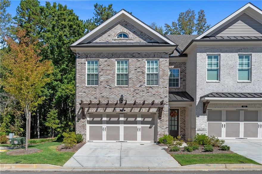 Experience refined sophistication in this better-than-new, move-in-ready end-unit townhome, a true gem of Johns Creek. Built in 2024 and upgraded with over $150,000 in high-end finishes, this residence blends modern luxury with timeless elegance.

Enjoy the space and comfort of a single-family home without the hassle of constant maintenance. With a low $235 monthly HOA covering lawn care, roof, and exterior upkeep, you can focus on living beautifully and effortlessly.

Step inside to find soaring ceilings, 9-foot doors, and Level 5 hardwood floors throughout. The designer fireplace with modern tile sets a stylish tone, while sunlight pours in through large UV-protected windows adorned with custom designer blinds.

The chef’s kitchen is both functional and breathtaking — boasting ceiling-height cabinetry, premium hardware, a farmhouse sink, luxury faucet, built-in double trash pullout, quartz countertops, and GE Profile stainless steel appliances. A wide sliding glass door opens to a covered patio overlooking the fenced backyard, perfect for morning coffee or evening gatherings.

Upstairs, the primary suite offers a spa-inspired retreat with upgraded tile and a frameless glass shower enclosure. The expansive finished third-floor suite includes a full bath, ideal for guests, a home office, or a private recreation space—providing even more living area than a traditional basement.

Every room is enhanced with modern ceiling fans and custom touches that reflect thoughtful craftsmanship and design.

Nestled in a secure gated community with a residents-only pool and dog park, this home offers not just comfort, but peace of mind. Located within the top-rated Johns Creek High School district, and moments from fine dining and upscale shopping, this home perfectly combines luxury, convenience, and location.

Come experience the warmth of sunlight, the calm of nature, and the effortless elegance of this exceptional home.
This isn’t just a home—it’s a lifestyle you’ll fall in love with.

Schedule your private showing today.