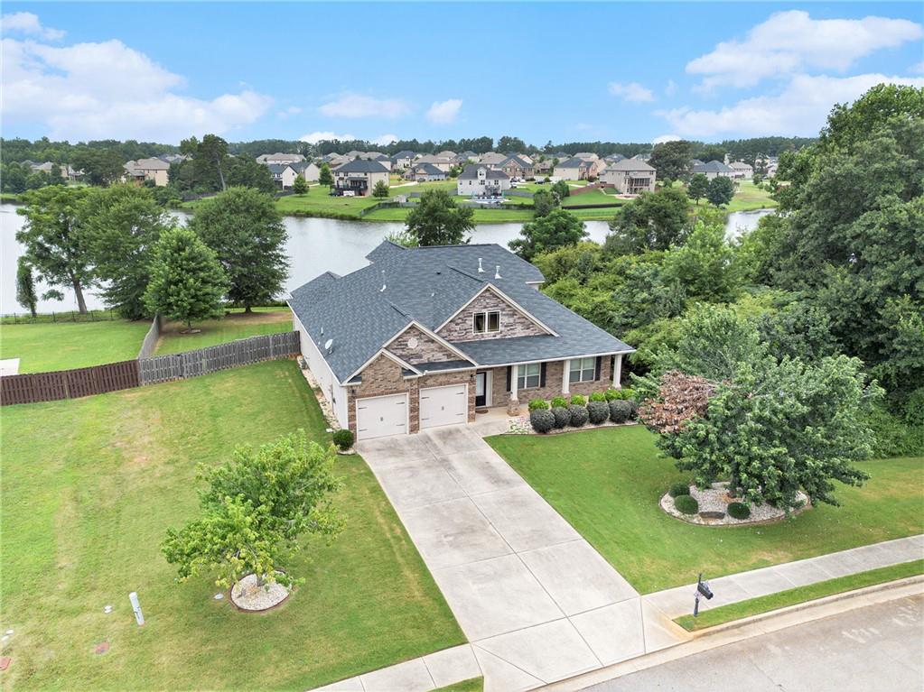 Stunning Lakefront 4-bedroom, 3.5-bath home in the highly sought-after Lake Iris at Williamsburg subdivision, offering every amenity you could want. This beautifully designed residence features a spacious open floor plan with a large eat-in cook’s kitchen that flows seamlessly into the vaulted great room with a cozy fireplace. The oversized owner’s suite is thoughtfully separated from two generous secondary bedrooms and a shared full bath. Upstairs, a massive loft area offers endless possibilities for an office or additional living space, along with a fourth bedroom featuring a sitting area with breathtaking lake views and a private en suite. Enjoy your own outdoor oasis with screened-in porch, private lake access, and the potential to add a boat slip—perfect for peaceful lakeside living. This won't last!