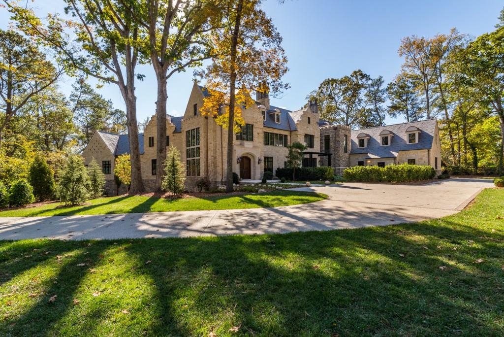 Spectacular new construction, this gated and fenced English Manor home sits regally on 1.8 acres at the corner of Garmon and W. Garmon. The entire home is stone, and the L shaped design includes massive windows from all sides so the light pours in. 12 ft ceilings, slate roof, elevator, pool, outdoor living space and antique mantels are a few features. The level of finish is cutting edge, as it was the stage for the 2015 Holiday Show house. There is space to add bedrooms, the terrace is open and includes bar and home theater. New landscaping added for additional privacy!