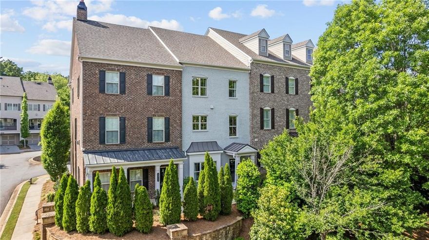 Encore Walk offers executive townhomes in Alpharetta in a community of just 38 homes. The property provides convenient access to Alpharetta's greatest amenities such as the Big Creek Greenway, the Alpha Loop, Ameris Amphitheater, Top Golf, Avalon, downtown Alpharetta and the North Point Corridor. The Fulton County Science Academy is less than half a mile away and the #1 Ranked Private School in the State of Georgia in 2025. There are also amazing public schools including Milton High, Northwestern Middle & Manning Oaks Elementary.  As you enter your new home, you will enjoy the private main floor entry that features a bedroom and full bath, currently used as an office. The main floor features an open floor plan with 10-foot ceilings on the main level, upgraded hardwood floors, 42” White Cabinetry with light Quartz countertops, subway backsplash, Stainless Steel Gas Range with built-in microwave, dishwasher and matching French Door Stainless Steel Refrigerator. This floor plan features the largest island in the community with plenty of room for 4 stools, an open dining area and a beautiful Great Room with a Gas Fireplace and slate surround. The covered deck area spans the entire length of the home and is the perfect outdoor retreat. Upstairs you will enjoy two secondary bedrooms, a hall bath and the convenience of an upstairs laundry room with the washer and dryer included. The owner’s suite is ideal with plenty of space for a sitting area or desk area. The owner’s shower is very spacious, stunning floor tile, wall tile and large bench area. You cannot beat this incredible location combined with these amazing features and spacious floor plan. The home has been freshly painted. This property provides the best location and easy access to all the amenities you could want. Welcome home!