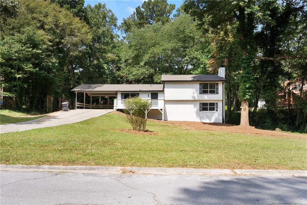 Stunningly renovated 4 bed/2 bath featuring brand new Luxury Vinyl Plank flooring, brand new 30-yr Architectural Roof, new HVAC, new interior and exterior paint, new lighting and plumbing fixtures everywhere, new granite countertops in kitchen and bathrooms, and new stainless-steel appliances. Home offers beautiful curb appeal with a 2-car carport and large front porch. Enter into the large open floorplan living room offering large windows to allow in lots of natural lighting and views to the kitchen. Kitchen offers new granite, plenty of cabinets and countertops space, island with overhang perfect for barstools, stainless steel appliances, and large eat-in dining area. Master bedroom offers an En-suite with tub/shower combo, new granite on the double vanity, and low flow toilet. Two good sized secondary bedrooms and secondary bathroom upstairs with walk-in shower, low flow toilet, and new granite. The basement offers a large recreation room/den/second living room with fireplace and 4th bedroom. Out back the deck overlooks the large backyard and storage shed.