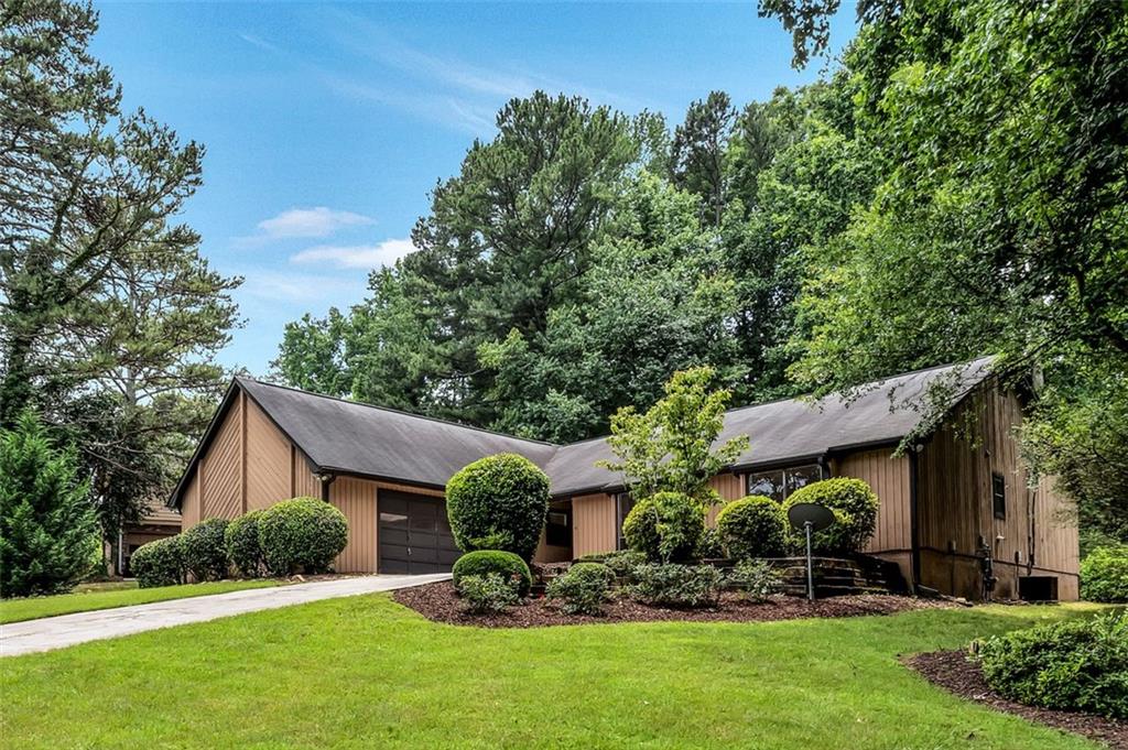 Live relaxed and easy in this full-size 3 bedroom, 2 bath home with separate living room, dining room family, and eat-in kitchen. Grand family room with vaulted ceilings, built-in bookshelves, floor-to-ceiling stone fireplace, and a wall of sliding glass doors leads right to a covered patio and the private landscaped backyard. Large eat-in kitchen features stainless steel appliances and pantry. Easy access to the two-car garage that has ample built-in storage and a utility closet. Primary bedroom has vaulted ceilings and leads to a private deck overlooking the landscaped backyard. Primary bathroom suite features dual sinks, separate tub/toilet room, and access to a walk-in closet. Home is freshly painted throughout with newer carpet. Easy access to major freeways, Stone Mountain Park. This house is in great condition and in a location. You can move right in! If listing broker shows first, buying broker commission will be reduced to 1% commission. Accepting offers until 11:59PM Saturday, 06/17/2023 please allow until at least 5:00PM, Sunday 06/18/2023 for a response. (Some images included in the listing have been virtually staged to help showcase the intended use and true potential of spaces in the home.)