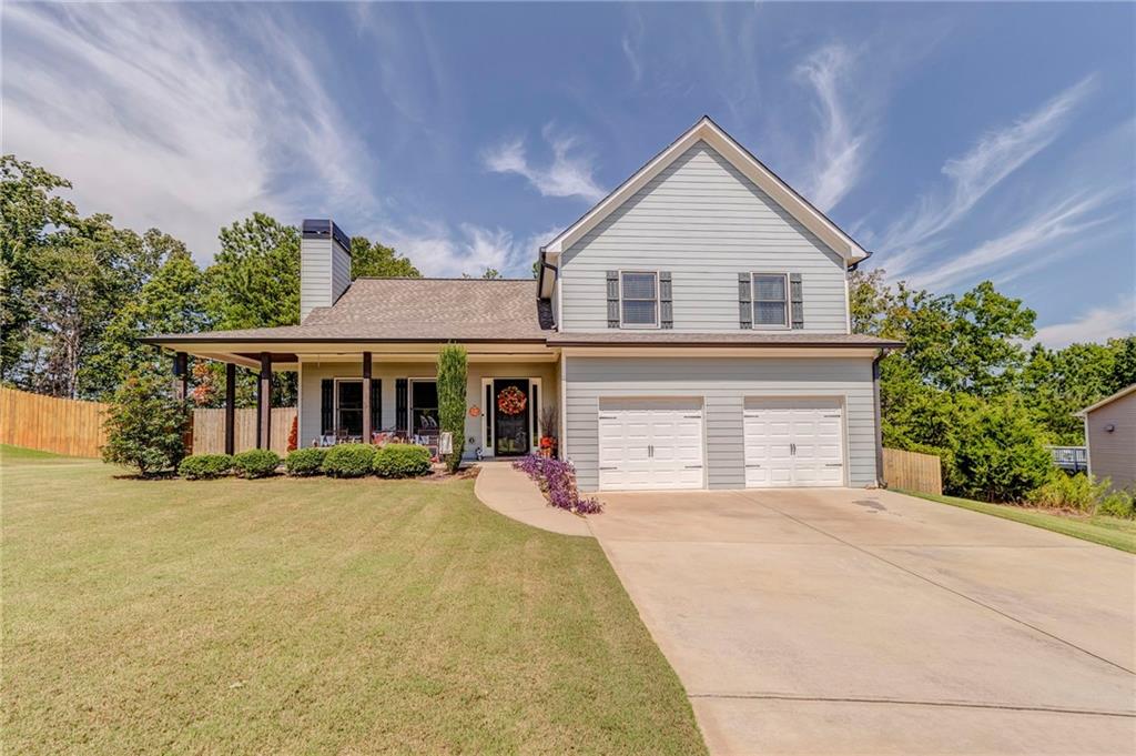 USDA eligible! Welcome to your new home that merges open-concept living with elegant, low-maintenance design, nestled in a thriving community in Rockmart, GA. This 1900sf (approx) 4-bedroom, 2.5-bathroom gem sits on a generous 0.35acre lot in Rockmart's beloved swim/tennis Arbor Chase subdivision. Step through the welcoming front porch into an inviting great room that flows into the kitchen and dining areas. Rich hardwood floors stretch beneath your feet-from the heart of the home in the kitchen to the communal spaces-each step whispers warmth and quality. The kitchen shines with gleaming granite countertops, a stylish tile backsplash, and stainless appliances, setting the stage for culinary adventures and gatherings alike. Every bathroom continues the theme of sophistication with granite surfaces and durable tile underfoot. Retreat upstairs to your private sanctuary. The owner's suite boasts tray ceilings that lend grandeur, a capacious walk-in closet, and a layout made for relaxation. The home's architecture blends beauty with practicality: cement siding lends durability, while the composition roof ensures longevity and peace of mind-designed for both aesthetic appeal and ease of upkeep. Outside, the covered patio overlooks a backyard that's yours to personalize-a perfect setting for evening grilling or quiet morning coffee. With ample space on the half-acre, there's room to create a garden, play area, or serene retreat. The neighborhood feel remains strong, with gathering space aplenty at the community pool, tennis/pickle ball courts, picnic area and playground, fostering friendships and childhood memories. At just $400 per year, the HOA fee ensures these amenities remain pristine without breaking the bank.