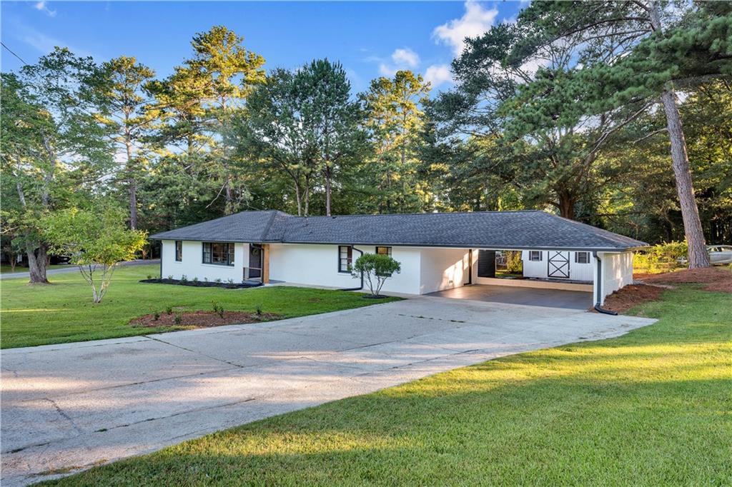 Welcome to this beautifully renovated 4-bedroom, 2-bath ranch-style home on a spacious corner lot! This move-in ready gem features a bright, open layout with brand-NEW quartz countertops in the kitchen and bathrooms, NEW cabinetry, and all-NEW appliances. Enjoy the comfort of luxury vinyl tile flooring, plush NEW carpet, and updated electrical and plumbing fixtures throughout. The HVAC system, water heater, and A/C compressor have all been professionally maintained for peace of mind. Step into the covered sunroom—a perfect space to relax or entertain year-round. The home has been freshly painted inside and out, with a landscaped yard and a new mailbox enhancing its curb appeal. Stylish, modern, and move-in ready—this home is waiting for you to make it yours!