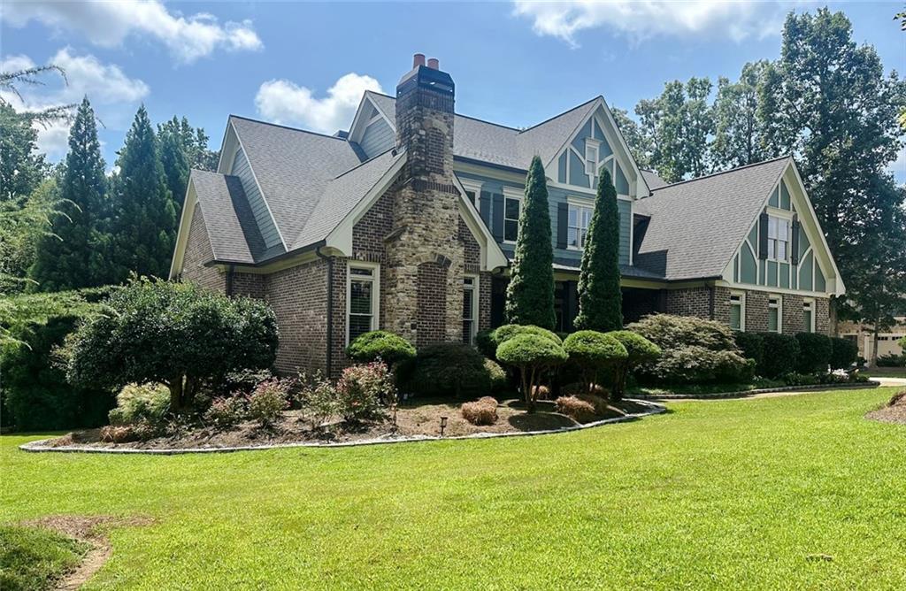 Nestled within the prestigious Country Club community, this exceptional luxury Craftsman-style home graces a serene corner lot, exuding timeless elegance and modern opulence. The residence boasts a commanding presence with a rear-facing 3-car garage, while its distinctive architecture is complemented by high ceilings and a grand entrance with a soaring foyer. With a generous expanse of 8,351 square feet, featuring 6 bedrooms and 4.5 baths, this residence offers a master suite on the main level with an intricately vaulted ceiling and a separate office adorned with a cozy fireplace. Hardwood floors adorn the entirety of the open-concept layout, designed to capture abundant natural light. The heart of the home is a culinary masterpiece, replete with a spacious island, breakfast bar, and wine racks, while a keeping room and screened patio invite relaxation. Crown molding graces each room, embodying a regal touch. With three fireplaces elegantly distributed throughout the home, and bedrooms upstairs boasting double jack-n-jill bathrooms, architectural details elevate both aesthetics and convenience. The fully finished basement is an entertainer's dream, boasting a theater room, conference room, game room, wine cellar, and bar. Atop a top-tier school district and surrounded by the beautiful golf course community, this home provides an idyllic setting for enjoying life's pleasures.