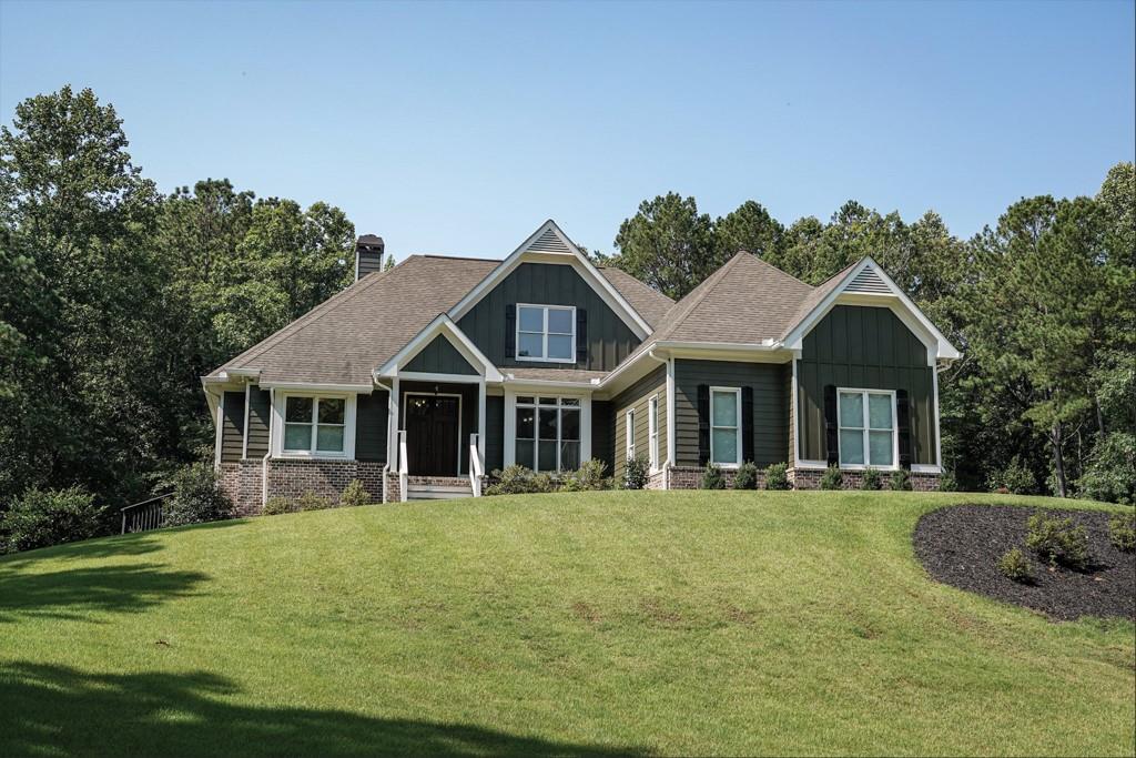 Feel like you're on vacation every day! Main level has just been freshly painted in alabaster white. This beautiful custom-built 5 bedroom, 4 bath home in the sought after North Paulding district sits on 2.5 acres of lush green grass and gorgeous hardwood trees! It overlooks a private, beautifully landscaped front yard w/ sprinkler system and the backyard is even better with an inground pool w/ waterfall feature, cabana and lighted stone firepit area. If total privacy with convenience to shopping, schools and restaurants is what you want, this is it for sure! Only 8 years old, having been meticulously maintained, and just freshly painted throughout, it's ready for you to move right in. Absolutely nothing to do or improve! It's spotless clean and fresh! Soaring ceilings in the great room, with a wall of windows overlooking the gorgeous backyard, it feels like you are looking at a picture of paradise! Beautiful hardwood floors throughout except for bathrooms which are tile. The kitchen has lots of cabinets, in fresh white, with nice granite counterops and stainless appliances. Enjoy your breakfast by the bay of windows and watch the deer feed in your backyard! With the open floor plan, there is plenty of room when guests come over, not to mention it flows out to a large covered porch AND large uncovered deck for outdoor entertaining. Step off to the deck directly onto the pool patio and enjoy the pool, vegetable garden, lighted fire pit and totally private backyard! The secondary bedrooms have their own bathrooms making it perfect for family or guests. Oversized primary bedroom is on the opposite side of the home, providing total privacy and peacefulness with a wall of windows showcasing the beautiful backyard and wooded acreage views. Large ensuite bath featuring separate soaking tub and walk in shower. Huge walk-in closet and large double vanity area. This REALLY is a FULL basement as it spans the total footprint of the home and already has one room and a bath framed in and ready to finish if you want. For bad weather days, there is a 6" concrete storm shelter area in the basement as well. The options are endless. Don't worry about expenses to operate the pool because there are solar panels on the roof that provide all the energy to heat the water and run the waterfall feature. You basically buy salt and enjoy your heated 18' x 36' pool for free! This home was made for entertaining with a lighted stone fire pit and large sitting area, lighted cabana and large open grassy backyard that is all fenced in. There is even a nice garden area inside the fence so the deer won't get to your veggies before you do! The property totals 2.5 acres of all useable land which is made up of a 2.0 acre parcel plus a contiguous perfectly shaped rectangular 1/2 acre parcel behind the house that actually has road frontage on Narroway Trail so if you don't need the full 2.5 acres you could easily sell off the 1/2 lot to generate some income or let a family member build on it. It's is perfect to park extra equipment, boat, camper, etc.. It is nice and level with mature hardwoods and would make a beautiful building lot! Large garage at kitchen level makes for easy access. You can tell how particular the owner has been with maintenance when you see the freshly epoxied garage floor... it is spotless and smells fresh and clean with plenty of room for tools, workshop, etc. He even put down pea gravel next to the driveway for additional parking. Plenty of room for parking! The front gate opens up and you can drive all the way thru to the back lot or around to the basement. No shortcuts taken here and everything has been well thought out to provide for carefree and comfortable living! The rear lot already has a driveway with a gate on Narroway Trail.