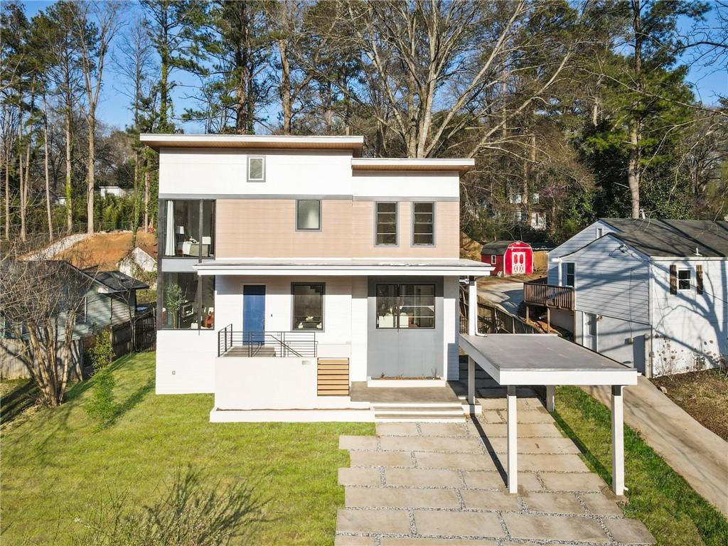 Welcome to your dream home in the highly sought after Woodland Hills neighborhood! This beautiful newer construction is a 1 of 1 Californian Organic Modern that has been updated to keep up with the latest aesthetic and trends to the market, creating a timeless time capsule. Upon entry, you're met with an open concept with massive living common space, a dining area that can fit a 16 seater, and an imported custom cabinet kitchen that allows for seamless entertaining or everyday interacting with family and friends. The cardinal facing direction, elevations of lot, and enormous custom windows allows for the most serene and movie-like sunset settings 365 days of the year giving this home something that every space cannot attain. The kitchen boast higher tier appliances by Borsch, a four seater waterfall quartz island, and built-ins throughout the space for easy storing for items. The main level features a secondary primary bedroom with an ensuite and french doors connecting the covered decking space that occupies a Hot Springs Gleam salt water hot tub/jacuzzi that can seat up to 8 people at a time. Walking throughout will feature covered European White Oak Hardwoods and hand selected porcelain tiling with no seams or transition pieces for a fully custom flooring cover experience. Walking up custom hardwood staircase, the second level of home features 3 extremely generous size bedrooms, with all being attached to immediate access to a fully tiled custom bathroom. The primary bedroom (owner's suite) features its own exclusive private balcony space, dual custom vanity, walk-in closet, and more than enough space to add seating or storage of your liking. Proximity of home and neighborhood close to the newest Lifetime Fitness gym, Emory University, Buckhead, Morningside, interstate and expressways, shops, dining, MARTA and retail. If you're searching for a custom gem to call home that offers comfort, convenience, and evening scene like no other, this home is a must-see.