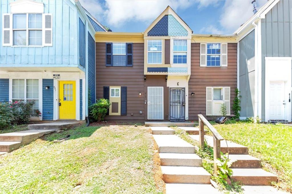 Welcome to this beautifully maintained two-bedroom townhome, thoughtfully designed for comfort and convenience. The kitchen features crisp white cabinets, a classic tile backsplash, and modern quartz countertops. All appliances—including a refrigerator, dishwasher, and stove—are included. A pantry offers added storage space, making this kitchen as functional. Enjoy cozy evenings by the stone fireplace with a custom mantle in the inviting living area, which opens to a private backyard patio through sliding glass doors—perfect for relaxing or entertaining. Both bedrooms are located upstairs for added privacy, with durable laminate wood flooring throughout. The staircase is carpeted for comfort, while the kitchen and bathrooms feature elegant tile flooring. The primary bathroom also boasts quartz countertops, tying in the upscale finishes seen in the kitchen. Don’t miss the opportunity to own this move-in-ready home that combines modern finishes with timeless charm.