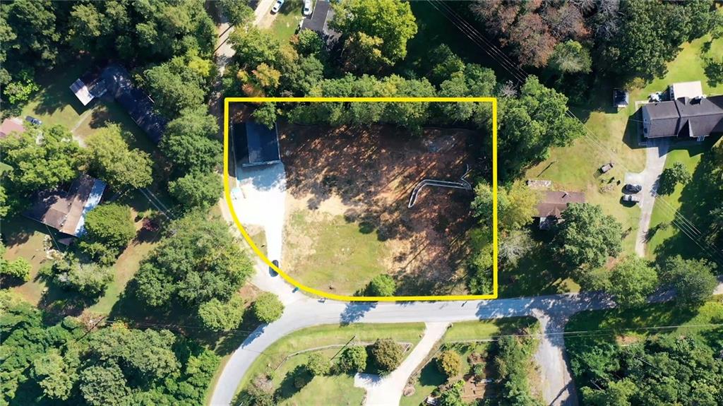 Welcome to 24 Polk Path in Dallas, Georgia. This unique one-acre property offers a rare opportunity for buyers seeking a homesite that is not only spacious but already thoughtfully prepared for construction. The land has been cleared, graded, and equipped with essential infrastructure, making it an ideal foundation for a custom-built residence or the placement of a mobile home. One of the standout features of this property is the newly constructed shop, designed with both functionality and value in mind. The shop is equipped with plumbing and its own water supply and is supported by its own dedicated septic system. The structure is complemented by an impressive 60-foot retaining wall, adding both structural integrity and an attractive finished look to this side of the parcel. The designated house site is equally impressive and ready for immediate development. A newly installed septic system, sized for a three-bedroom, two-bathroom home, is already in place. The house pad sits on an 80-foot double retaining wall that includes carefully designed side steps, creating an appealing and practical foundation for the home. A conveniently located water supply near the pad further enhances the property's readiness for construction. This property combines practical preparation with long-term potential. Whether you are looking to build your dream home from the ground up or place a mobile home on a well-prepared lot, the groundwork has already been done for you. The seller also has receipts, surveys, soil tests, and perc tests available for review, providing full transparency and peace of mind to the buyer. 24 Polk Path presents an excellent opportunity to invest in land that offers both immediate usability and future potential. At a list price of $150,000, this property is a strong value in the growing Dallas area. Schedule a showing today and see firsthand the possibilities this property provides.