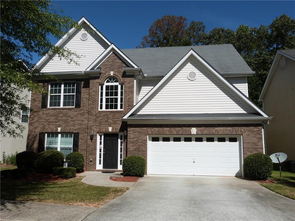 Lovely two-story home that features a 2-story entry with living room/flex room, separate dining room, family room with fireplace, ceiling fan, and access to the rear patio. There is a half bath and access to the 2-car front entry garage. Open kitchen with Formica counters, kitchen island, tile backsplash, all stainless appliances (gas stove, dishwasher, microwave and refrigerator), disposal and pantry. Upper level has the laundry room with washer/dryer included (owner will not repair or replace the washer & dryer if they stop working). There are three spare bedrooms that share a full hall bath with tub/shower combination. The master is spacious and has a sitting area and ceiling fan, as well as two closets. The master bath has dual vanities, soaking tub, and separate shower with enclosure. Great schools. Near shopping & dining, close to Stonecrest Mall and Lenora Park. Easy access to I-20, Hwy 78, and Scenic Highway.