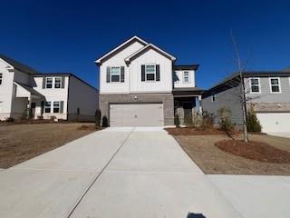 View of front of property featuring a garage and driveway