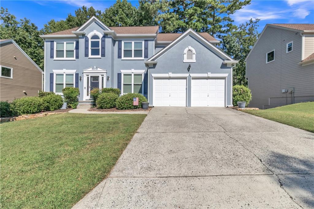 A must-see in Johns Creek! This spacious 4BR/3.5BA w/ a Full Finished Basement has more to offer than you would imagine. Home sits at the end of the street, just before a cul-de-sac on a private wooded lot. A two-story foyer opens to a bright, airy family room with a wall of windows and cozy fireplace. Main-level office with French doors, hardwood floors, and fresh neutral paint. Kitchen features white cabinetry, center island, gas range, walk-in pantry, and plenty of room for entertaining. It's ready for your personal touch. Oversized primary suite with tray ceiling, garden tub, and separate shower; secondary bedrooms with double vanity bath. The finished terrace level offers natural light, media room, wet bar, sleeping quarters, and full bath. Perfect for entertaining or multi-generational living. Relax on the oversized deck overlooking the wooded backyard. Swim/tennis community in top-rated Chattahoochee & Findley school district. A short drive to downtown ATL, Buckhead, Midtown, a Getaway to Lake Lanier or the North Ga Mountains. You're also Minutes from Emory Hospital, Avalon, Halcyon, Medley at Johns Creek, Big Creek Greenway, parks, shopping, gyms, dining, and much much more