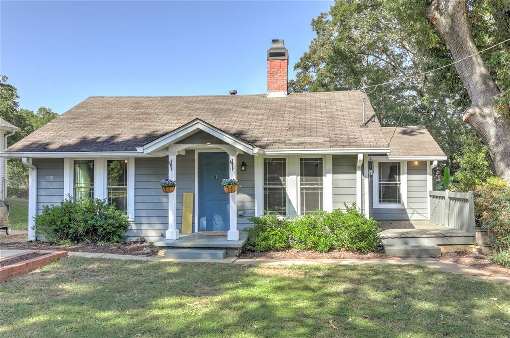 Charming renovated Bungalow perfectly located in heart of downtown Buford. Walking distance to Main street & S Hill St. Stroll along for coffee, dining, and shopping. Parks & New Buford Stadium are also within walking distance.  Buford City Schools recently ranked # 1, the best in Georgia, & this area is one of the most sought after locations in Georgia.  This darling homes interior is freshly painted and has lots of natural light with new windows throughout,vaulted ceilings, sizable Dining area, oversized primary bedroom with good size closet and 2 additional bedrooms and 2 baths. The kitchen is perfect for cooking with a pantry and losts of cabinets.  Fenced in backyard is a dream for kids play, pets or enteraining with wraparound exterior deck that overlooks large yard.  Side Porch for morning coffee ,tea or cocktails sititing by an outside fireplace taking a break from the race of life.  An added plus is a partial unfinished basement w exterior entrance for storage.