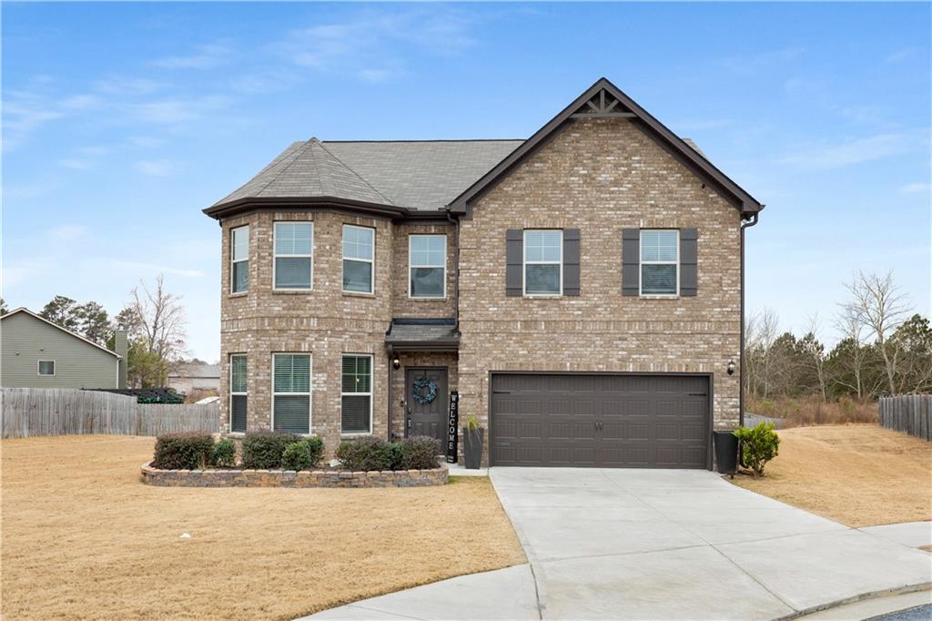 This beautiful two-story brick-front home is perfectly situated on a large, level lot at the end of a peaceful cul-de-sac. From the moment you step inside, you’ll notice the attention to detail, including elegant vinyl plank flooring throughout and stunning coffered ceilings that elevate the main living spaces. The spacious family room, featuring a cozy fireplace, flows effortlessly into the open-concept kitchen. The kitchen is a chef’s dream, complete with gleaming stone countertops, a convenient breakfast bar, white cabinetry, stainless steel appliances, and a sunny breakfast room for casual dining.
Upstairs, the oversized primary suite serves as a luxurious retreat. It includes a private sitting area and a spa-like en suite bathroom with double vanities, a deep soaking tub, and a separate glass-enclosed shower. Additional bedrooms offer ample space and versatility for family, guests, or a home office.
Step outside to discover a large patio, ideal for entertaining, and a sprawling backyard with endless possibilities for outdoor activities. This home combines modern elegance with functional design, making it perfect for both relaxation and hosting. Conveniently located near schools, shopping, and dining, this property offers the best of both comfort and convenience. Don’t miss your chance to make it yours!