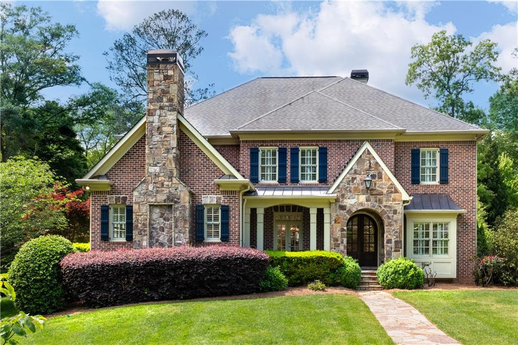 Nestled on a prime corner lot, this exquisite brick and stone home with a private pool is perfectly positioned just minutes away from Chastain Park, GA-400, Buckhead, and Brookhaven. As you enter through the grand double arched front doors, you are greeted by a charming covered front porch and an inviting foyer. The home features stunning, recently refinished light hardwood floors that seamlessly connect each living space. To the right of the foyer, you'll find a sophisticated office space, ideal for those who work from home. On the opposite side, a graceful dining room awaits, adorned with chair rail molding and French doors that open to the front porch. The great room is a true sanctuary, boasting a coffered ceiling, a magnificent masonry fireplace flanked by bookcases, and French doors that lead to the covered terrace overlooking the breathtaking backyard. The crisp white kitchen is a chef's dream, offering an oversized island with seating, high-end stainless steel appliances, exquisite granite countertops, and a convenient wet bar. From the kitchen, you can enjoy views of the sun-drenched breakfast area and the cozy fireside keeping room with a stunning cathedral ceiling. For added convenience, there is a well-appointed mudroom with built-in cubbies, perfect for keeping everyday clutter organized. The main level also features a luxurious guest suite with a beautifully detailed marble bathroom. Upstairs, the hardwood floors continue, creating a serene atmosphere. The tranquil primary suite is a true oasis, featuring a spacious bedroom with a tray ceiling, a wall of windows, and a delightful sitting room with a built-in bookcase. The recently renovated en suite primary bathroom boasts stunning quartz slabs and tilework, a double vanity, and a seamless glass wall leading to the wet room, which includes a large soaking bathtub and a shower with built-in product niches. Additionally, there are three more en suite bedrooms and a convenient laundry room on the upper level. The living spaces extend to the terrace level, offering a full bedroom, a bathroom, a versatile recreation room, a bar/kitchenette, a gym, and a home theater. The home is thoughtfully equipped with plantation shutters throughout, a three-car garage, a whole-house generator, three new HVAC systems with HEPA filters, and a whole-house water filtration system. The walkout backyard is an absolute paradise and can be easily accessed from the main level. Enjoy dining al fresco on the covered patio, complete with ceiling fans and ample space for a grill. The refreshing Pebble Tec pool features a sun shelf with jets, a spa with a waterfall, and a generous pool deck perfect for soaking up the sun. The fully fenced yard also includes a grassy play area and access to the terrace-level patio. Located in the highly sought-after High Point area of Sandy Springs, this home offers close proximity to nearby hospitals, restaurants, retail, City Springs, Buckhead, Brookhaven, expressways, and all the exciting amenities Atlanta has to offer.
