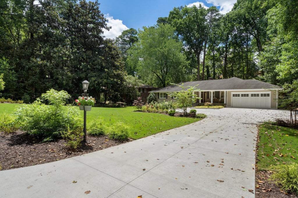 Absolutely precious Chastain ranch in prime location, steps to popular restaurants, shopping, and Buckhead's favorite park!  This tastefully updated home with hardwoods throughout has plenty of space for all of your needs.  Kitchen open to fireside keeping room and cozy sunroom leads you to walk-out flat, fenced backyard with bluestone patio perfect for entertaining.  Large primary suite with double vanity.  Huge finished basement with guest suite or fourth bedroom with renovated bath.  Two car garage, new driveway with extra parking and all new professionally landscaped front and back yard. This home has been well-maintained and includes a newer HVAC and hot water heater. Award-winning school district!  Enjoy the coveted Chastain Park lifestyle in this spacious gem!