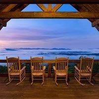 WAKE UP ABOVE THE CLOUDS AND FEEL LIKE YOU ARE WALKING ON AIR, in this lovely rustic lodge positioned on the Tower Road ridge. You will have a clear, long-range view of the surrounding mountains as you sip your morning coffee. The great room has a massive stone fireplace and flows effortlessly into the kitchen and dining area, then onto the outdoor living area complete with a fireplace, dining area and a rocking chair deck that runs the length of the house. This is a 4 bedroom, 4 ½ bath lodge with an ensuite arrangement, features spacious bedrooms, and stone showers. The rustic details including a brick wall with fireplace in the main bedroom make this cabin exceptional. The Lower Floor features a game room/family room with a bark wall, laundry room and two ensuite bedrooms. The Lower Deck has a hot tub, unique rustic swings, and an area for a ping pong table. This house has something for everyone, including an outdoor firepit with lighting and ornamental trees to encourage relaxation and an appreciation of God’s gift of nature. There are multiple possibilities for this lodge; it could be a second home, a permanent home, or a rental property. It is positioned next to a full-time resident and a part-time resident, with several new homes on Tower Road. It has generated excellent rental income since its construction in 2016, including $149,000 in 2022.