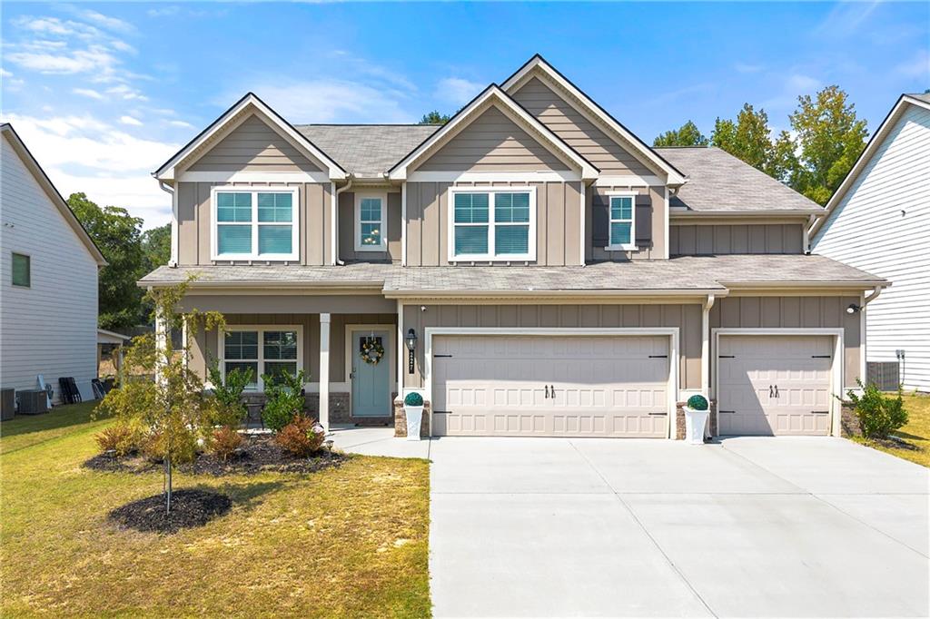 There is a certain kind of home that truly has it all, and this is one of them. Located in the sought after Eleanor subdivision, this newly built 2023 home blends modern design with thoughtful details throughout. Upstairs, you will find a spacious primary suite along with three generous secondary bedrooms, while the main level offers the convenience of an additional bedroom and full bath. With a rare three car garage, soaring nine foot ceilings, and a formal dining room with a coffered ceiling, the home is designed for both elegance and everyday living. The kitchen stands out with quartz countertops, a tile backsplash, a central island, and stainless steel appliances, all overlooking the open concept family room. Luxury vinyl plank flooring flows throughout the main living areas, and a direct vent fireplace with a decorative mantle creates a warm focal point. Details matter here. Metal spindles with wooden handrails, brushed nickel hardware, ceiling fans in the primary and family rooms, secondary bedrooms pre wired for ceiling fans, two inch faux blinds, and WiFi enabled garage door openers add both style and convenience. The driveway is illuminated with motion sensing flood lights for added peace of mind. This home has been thoughtfully designed, beautifully finished, and is move in ready. Schedule your private showing today and experience why this Eleanor subdivision gem is the perfect place to call home. Great Lender Incentives with Jerome Jackson with Southeast Mortgage.