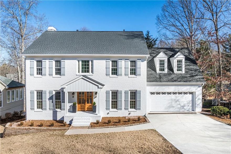 Welcome to Your Dream Home in East Cobb’s Sought After Lassiter High School District! Nestled in a tight-knit, family friendly neighborhood, it sits directly across from the neighborhood pool and tennis courts an ideal setting for building lifelong connections. From the moment you step inside the 6-bedroom, 5.5-bathroom home, you’ll be captivated by the open and airy floor plan, illuminated by stunning Restoration Hardware chandeliers, including an eye catching statement piece in the entryway. The main level exudes warmth and sophistication, featuring a newly installed stone fireplace. Designed for both function and style, the kitchen is an entertainer’s dream, boasting an oversized island, high-end hardware, a pot filler faucet, and a generously sized walk-in pantry for effortless meal prep. Step outside to the expansive newly finished deck, perfect for hosting gatherings or enjoying peaceful mornings overlooking the large, level, and fenced in backyard an ideal space for kids, pets, or outdoor entertaining. The primary suite is a true sanctuary, complete with a custom designed walk-in closet featuring ample shelving and storage. The spa like ensuite bathroom offers double sinks, a stunning walk-in shower, a large soaking bathtub, and a sleek modern LED mirror, all designed to enhance your daily routine. Upstairs, you’ll find three additional spacious bedrooms, each paired with beautifully renovated bathrooms. Every window in the home is brand new, flooding the interior with natural light. The finished basement is perfect for guests or multi generational living, featuring a large open floor plan, two additional bedrooms, and two full bathrooms and a kitchenette or bar for added entertainment space. All crafted with the same high end finishes as the rest of the home. Step outside from the basement to a charming patio leading to the beautifully fenced in backyard. Additional updates include: BRAND-NEW WHITE BRICK EXTERIOR WITH BRAND NEW SIDING AND A NEW ROOF NEW HARDWOOD FLOORS THROUGHOUT NEW DOORS, STAIRS, AND FRESH PAINT THROUGHOUT NEWLY INSTALLED BASEMENT STAIRCASE FOR EASY ACCESS With everything inside and out brand new, this home is truly move-in ready. Located in one of East Cobb’s most desirable communities, it offers the perfect blend of luxury, comfort, and community. Schedule your tour today and experience this exceptional home for yourself!