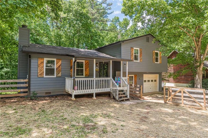 Adorable split level home ready for your family.  Inside has updated flooring and large living spaces.  Perfect space for a separate office downstairs separate from the main living space.  Cozy screened in back living space for relaxing and enjoying beautiful nights. Fenced front and back yard perfect for kids and pets.  Close to restaurants, schools and shopping.