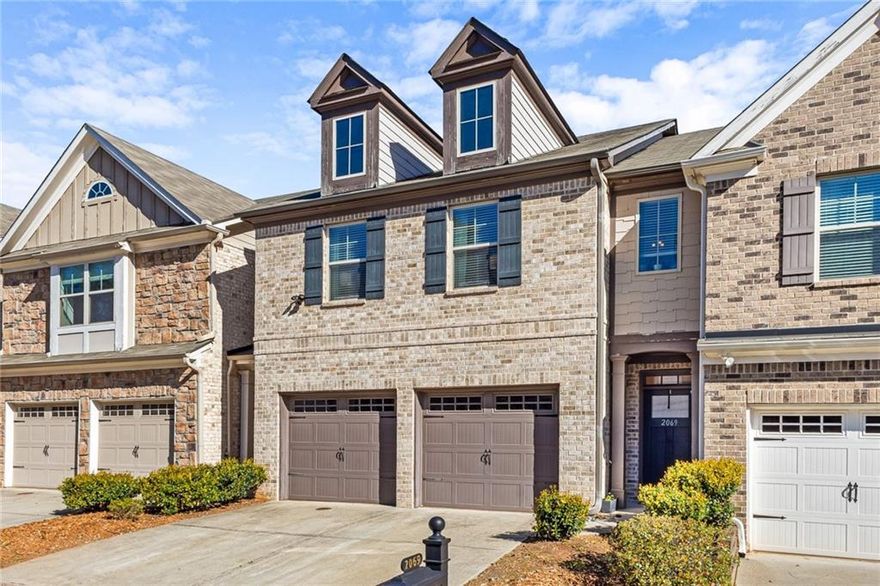 Price improvement - 1 year home warranty with accepted offer! Stunning 3-bedroom 2.5 bath Townhome in the desirable Caswell Overlook Community! Seller has invested thousands of dollars in quality upgrades for the home. Spacious open concept perfect for entertaining, with hardwood flooring throughout the main level. Seller also replaced carpet upstairs with solid plank hardwoods and replaced linoleum floors in second bathroom and laundry room with tile. High coffered ceilings in the great room along with beautiful built-ins, gas log fireplace with new custom fireplace surround.  Kitchen features granite counters, island, new stove, dishwasher, and garbage disposal installed in 2022.  Dining room features new chandelier.  Almost all lighting throughout the house has been upgraded from builder’s grade. You can also enjoy being outside with your private, fenced patio with raised garden beds. Upstairs, there is a huge loft/ flex space.  Seller installed a ceiling outlet with a shelf to use a projector and turn the space into a movie room!  Oversized master suite with tray ceilings, and luxurious master bath with soaking tub, dual vanities, and custom walk-in closet makes for a nice retreat.  Two additional bedrooms, a full bath and convenient full sized laundry room round out the upstairs space. Two car garage with automatic door openers. HOA includes water, trash, yard maintenance, pool, and playground. Fantastic location minutes from The Battery, Truist Park, Comet Trail and easy access to I-75 and I-285.