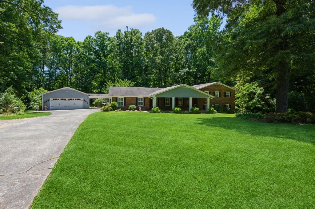 Crabapple location with Milton address on 2.398 acres.  Walk to the Library.  The home was built in 1967 but Owner has done major structural upgrades including an oversized detached 2 car garage with breezeway, extra large front porch, and Sun room.  The updated kitchen is spacious with an island and solid surface countertops.  Stained kitchen cabinets offer plenty of storage.  Interior Window Shutters and true eat-in kitchen.  Pendant Lighting, Double Ovens, Built in microwave.  Also a pantry/mud room combination.  The Master bedroom has also been enlarged and the ensuite bath offers a stepless shower.  Family room/Dining Room Combination with built-in bookshelves and brick fireplace.  Upstairs are two spacious bedrooms and two bathrooms - 1 with ensuite bath. The basement offers a finished room and an exterior door.  The yard is a gardeners dream.  Heirloom plantings and shrubs with a rock patio and several outbuildings.  Spacious grounds offer the buyer the ability to build to meet their needs.   Well pump was replaced in 2008, Furnace 2016, New Septic field lines 2021, Hot water heater 2023, new fiber internet installed.