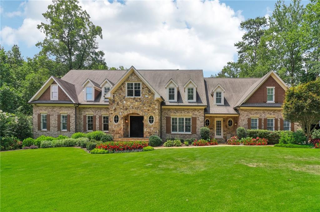 Impressive gated estate home with pool ideally situated on private 2 acres in the heart of Sandy Springs! Custom built in 2016, this home effortlessly combines luxury finishes and large gracious rooms. Exquisitely manicured level front yard with beautiful landscaping welcomes you to this stunning property. Main level features a two story entry, a formal dining room, fireside living room, dedicated executive office, primary suite, and a welcoming keeping room with a stone fireplace that opens to the kitchen. True chef's kitchen ready for all your culinary creations! Top-of-the-line stainless appliances: dual Asko dishwashers, Hallman range, Samsung refrigerator, separate ice maker, Kraus stainless sink and more! Huge island, marble counters, walk-in pantry, shelved catering closet, and custom cabinetry. The primary suite on main has a fireplace with marble surround, sitting room, large custom closet and spacious ensuite bath. The upper level has so much space - large ensuite bedrooms with incredible closets, two hangout/den areas, full laundry room with sink, and a private entry guest suite. The terrace level has everything you need! Large family room, two game rooms - space for pool table and ping pong, theatre room, full second kitchen with bar area, and terrace level patio. Check out the custom workshop with built-in cabinetry and tons of shelved storage space in the unfinished basement. A few features not to be missed include 10' ceilings throughout, home generator, 4-car garage, space for elevator if desired, hardwired smoke detectors, security cameras, irrigation system, covered porch with remote screens, and so much more! The backyard is truly a private oasis. Saltwater, heated resort-style pebble-tec swimming pool and spa with a waterfall feature and large sundeck. Lush landscaped gardens with walking paths and a potting shed provide an escape - here you will find raised beds with tomatoes, green beans, okra and countless flowers, trees & shrubs. Custom firepit area is the perfect gathering spot! Located in the award winning Heards Ferry Elementary, Ridgeview Middle and Riverwood High School district! Close to Buckhead, Chastain, great restaurants, shopping, hospitals and everything Sandy Springs has to offer! This home is perfect for those who appreciate superb quality, privacy, entertaining and outdoor beauty.