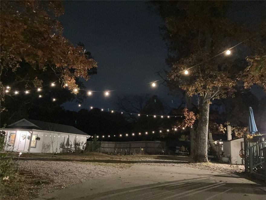 The property begins with a fully finished detached carriage house, currently used as a successful Airbnb. The sellers report steady bookings at $80–$120 per night, offering an immediate income opportunity or a comfortable space for guests, extended family, or a private workspace.

Between the carriage house and the main home is a large open area—an inviting, flexible space perfect for gatherings, fire pits, or simply enjoying the glow of the string lights in the evenings.

The 1941 farmhouse itself is a single-story ranch with a warm, cozy interior. Inside, you’ll find a layout that feels comfortable and lived-in, with the kind of character only an older home can offer. It’s an easy home to settle into, with spaces that feel welcoming from the moment you walk in.

Located near Hamilton Mill and just 10 minutes from the Mall of Georgia, this property blends charm, flexibility, and a convenient Buford setting—an ideal fit for a first-time buyer or anyone looking for a home with personality and potential.