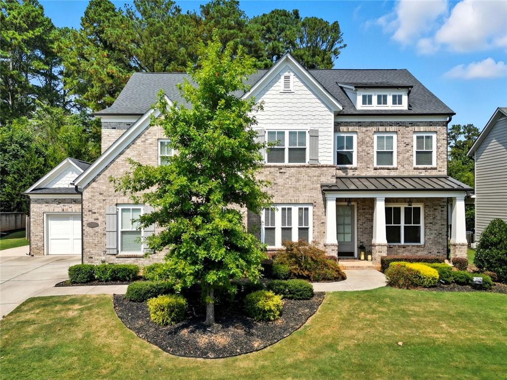Welcome to 2163 Mitchell Road, a beautifully crafted home built in 2018, ideally nestled in the heart of East Cobb within an award-winning, top-rated school district. This exceptional residence offers five generously sized bedrooms, four full bathrooms, and a spacious three-car garage, all set within a highly coveted neighborhood known for its outstanding amenities and vibrant, active social community. From the moment you step into the grand two-story foyer, you’ll be captivated by the soaring ceilings and the breathtaking wall of floor-to-ceiling bay windows that flood the great room with natural light and frame picturesque views.
Thoughtfully designed with both elegance and function in mind, the home features gleaming hardwood floors and a well-appointed layout that includes a dedicated office or flex space, as well as a formal dining room perfect for hosting gatherings. The main level also boasts a private guest suite with a full ensuite bath—ideal for visitors or multigenerational living. At the heart of the home lies a stunning open-concept kitchen, complete with a large center island perfect for entertaining, a cozy keeping room with a gas fireplace, and seamless flow into the sunlit living room featuring an elegant electric fireplace and direct access to the outdoor patio.
Step outside to discover a private, fenced backyard—an inviting retreat designed for relaxation and outdoor entertaining. Upstairs, you'll find four additional bedrooms, including a luxurious and oversized primary suite that serves as a true sanctuary. This tranquil space offers dual vanities, a soaking tub, a spa-like shower, and an expansive walk-in closet. Each secondary bedroom is complete with its own walk-in closet, providing ample storage and personal space for everyone.
With thoughtful upgrades throughout and designer touches at every turn, this home stands apart as a rare find. Don’t miss the opportunity to experience the perfect blend of comfort, sophistication, and location—schedule your private showing today!
