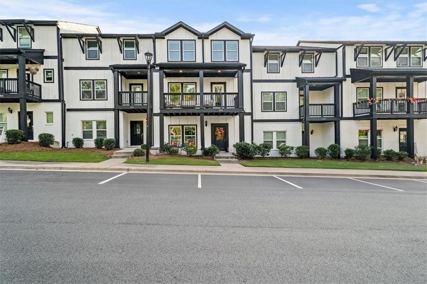 Overlooking a Nature Reserve with no neighbors in front, this stunning 3-story townhome is completely move-in ready! Tucked away in a quiet setting yet close to shopping, dining, and commuter routes, it offers the perfect balance of privacy and convenience! Inside, you’ll find an open-concept layout ideal for both daily living and entertaining. The exterior features a crisp design with bold black-and-white contrast, charming front porch, and two covered balconies looking onto the beautiful nature reserve — expanding your living space outdoors. The kitchen shines with modern finishes, an oversized island, double ovens, a gas cooktop, and flows seamlessly into the sitting area, dining space, and family room. Upstairs, the primary suite features a spa-like bath and generous walk-in closet. Secondary bedrooms are roomy and versatile! The finished lower level adds even more flexibility—whether you need a media room, playroom, or fitness space. Added bonuses: Brand NEW CARPET, freshly PAINTED INTERIOR, a 1-YEAR 2-10 Home Buyers Warranty, and up to $5,000 in seller paid CLOSING COSTS!!  With low-maintenance living in a well-kept community and the peace of mind that comes with a newer build, this home truly checks every box. Enjoy resort-style community perks like scenic walking trails, a sparkling pool, and the convenience to downtown Woodstock!