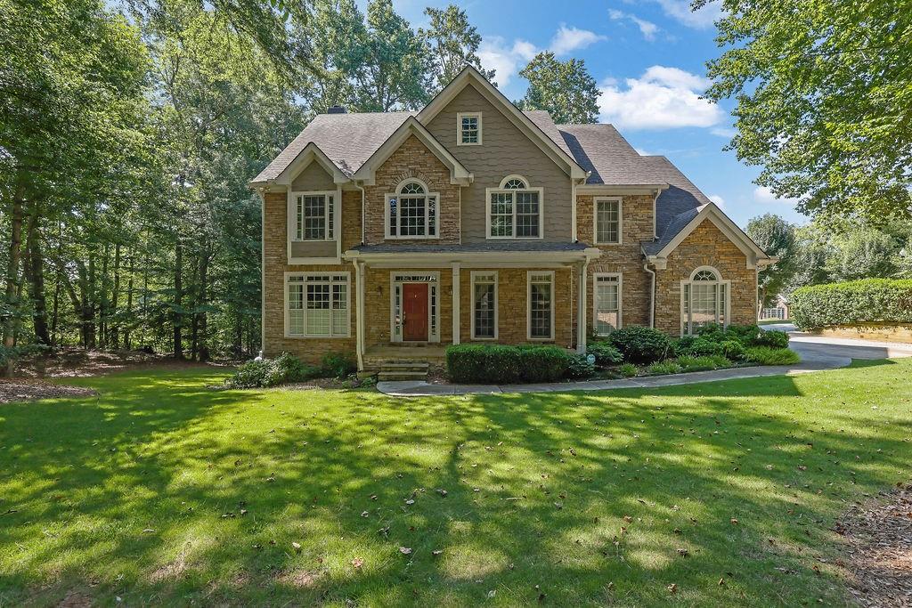 Come see this rare 5-Bedroom Home with In-Law Suite in Prestigious Arnold Mill Estates! Discover this residence perfectly positioned on a serene .92-acre lot backing up to Berry Patch Farms for unmatched privacy. Step inside the welcoming two-story foyer and be greeted by gleaming hardwood floors and an open, functional floor plan ideal for both everyday living and entertaining. The chef’s kitchen features stainless appliances, granite countertops, double ovens, island and a spacious eat-in area, perfect for entertaining. An expansive primary suite offers the ultimate private retreat: complete with an oversized sitting or living room featuring an inviting fireplace and a joining half bath. The spa-inspired primary bathroom showcases custom tile work, a separate soaking tub and a walk in shower- perfectly blending elegance with everyday indulgence. The finished basement with full in-law suite provides exceptional flexibility for multi-generational living or long-term guests. Additional highlights include a 3-car garage, abundant natural light, and room for a pool! This move-in-ready home also offers convenient access to Downtown Woodstock, shopping, dining, parks, and top-rated schools—all within a private, exclusive neighborhood setting.