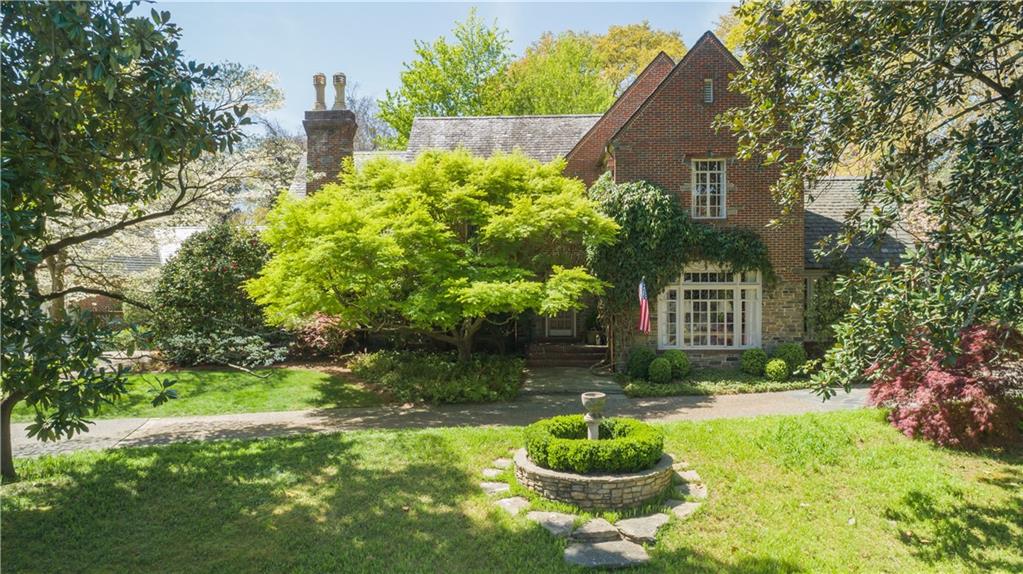 This English estate of mellow brick and stone was designed by noted Atlanta Architect James C. Wise in 1938 and is located in one of the most beautiful neighborhoods in Atlanta. The handsome entrance hall with pegged walnut floors and iron stair railing sets the stage for an impressive sequence of public spaces, beginning with the banquet-sized dining room, whose expansive bay window overlooks the pool and back yard. The stunning living room is anchored by an antique marble fireplace and streams with natural light from the wide, original iron windows. Other main floor rooms include the charming music room with painted wood cathedral ceiling, a richly paneled fireside study, the renovated eat-in kitchen open to the family room with built-in bar and French doors to the patio and pool. Adjacent to the kitchen and family room is the conservatory addition, with limestone floor, beamed cathedral ceiling, French doors, and raised stone fireplace. A guest bedroom with private bath and additional full bath are also on this floor. A renovated laundry room/mudroom overlooking the courtyard garden is adjacent to the entrance from the two-car garage. From the laundry room you step down to a bonus room, which is currently an office. Upstairs, the primary fireside bedroom suite features a luxurious new marble bath designed by Norman Askins. A sitting room connects two more bedrooms and baths on this level; there is also a playroom and walk-in attic. A rec room and game room are found on the terrace level. The meticulously maintained property is approximately1.5 acres. The yard and pool area were designed by Landscape Architect John Howard. The screened gazebo is accented by mahogany doors and bluestone flooring and has electrical and plumbing service.