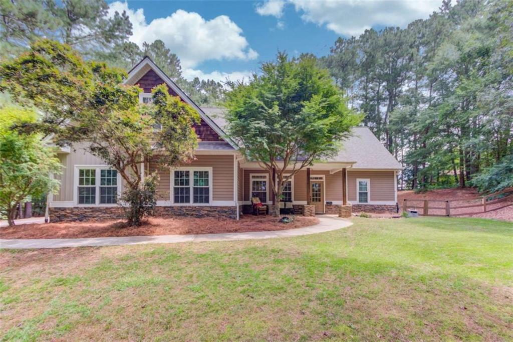 Welcome to your private retreat! This 2,256 sq. ft. home, built in 2006, sits on a beautifully wooded 1.08-acre lot offering peace, privacy, and room to roam - all with no HOA restrictions. 4 bedrooms and 3 full bathrooms, this well-maintained home includes a finished bonus room ideal for a home office, playroom, or guest suite. The open-concept living area provides a welcoming flow for both everyday living and entertaining. Step outside to experience outdoor living at its best with a large above-ground pool, complete with surrounding deck and portico make it easy to host gatherings, complete with a huge screen TV for watching sports, a fire pit, and room to relax. There's also plenty of covered parking with a pole barn at the top of the driveway-perfect for an RV, boat, or extra vehicles. And the fully fenced backyard is ideal for giving both your pets and kids a safe place to play. The home has tons of storage and extra closet space to help stay organized. It's in a fantastic location-just minutes from shopping, restaurants, and top-rated schools, as well as nearby parks. Despite the convenience, it still offers plenty of privacy and a peaceful atmosphere.