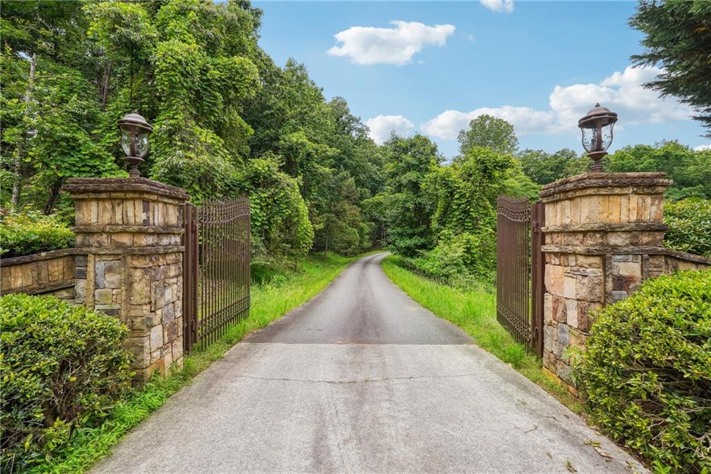 Bring your choice of builder and start your dream lake retreat in one of the
well established lake neighborhoods. 6.6 Acre Deep-Water Lot In A Very
Private Luxury gated Community with the luxury properties On Lake Lanier.
100 FT Of Corp/Waterfront Footage, All City Utilities are available, Covered Six
Slip Community Dock With Party Deck On Top.There is an easy walking path
to the dock.1 Dock Slip Included In Sale. Total of 3 Lots Available, From 2-6
+/- Acre Each, 1 Dock Slip Included With Each Lot.