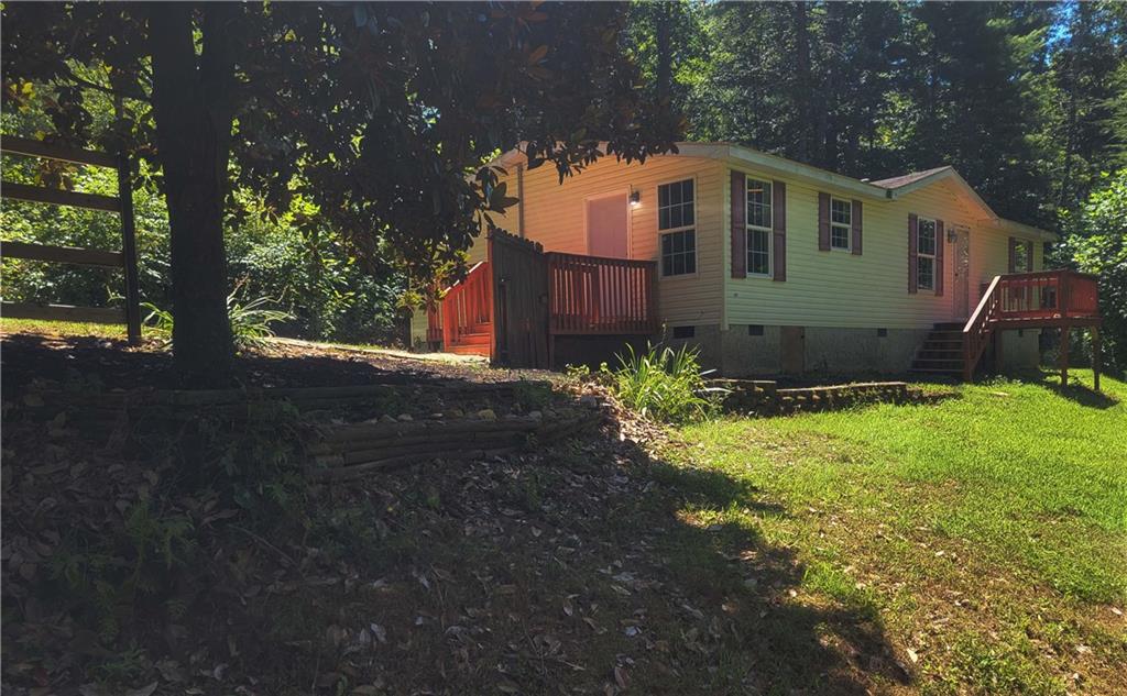 Have you ever dreamed of owning a home in the North GA mountains? Check out our Virtual Tour on the revolving home above! CRAZY LOW PRICE for this 1.2 acres of mountain solitude only 20 minutes from downtown Ellijay. NO DOWN PAYMENT REQUIRED on owner occupants with the USDA! MOVE IN FOR AS LITTLE AS $4500 TOTAL!!!..with a seller contribution toward closing costs. Perfect for your own second home mountain retreat! This 3 bdrm/2 bath cottage is 1344 sqft with treed views and sits on a partially fenced homesite with plenty of parking. Located only 20 minutes from the exploding Ellijay downtown shopping, dining and night life. The home is also located near 12 mountain area Wineries! Low maintenance LVP ENGINEERED FLOORING, has newer blinds, maintenance free siding and includes the washer/dryer/frig. The OPEN floorplan has a LARGE LIVING AREA with a cozy wood burning fireplace. The LARGE DECK is divided up into a sun-lit outdoor section and a SCREENED in area as well. New well pump means no water bill! Property taxes are only $303/per year at present! Tremendous Air BnB rental potential!