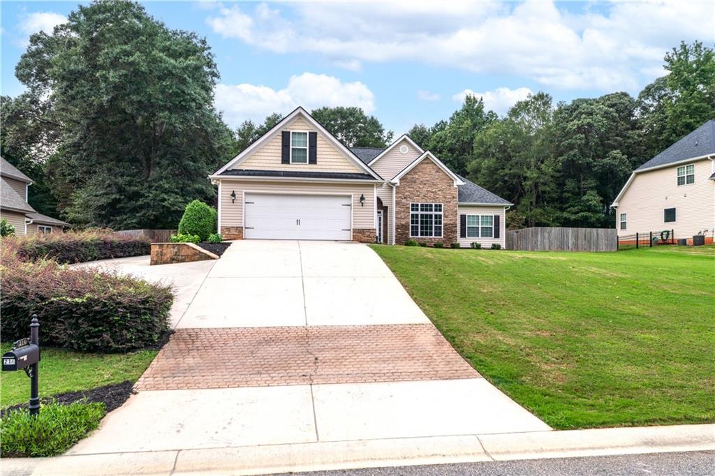 Nestled in Jackson County just off Hwy 129 between Athens and Jefferson, this 3 bed/2 bath home offers the perfect blend of comfort, style, and outdoor living. Step inside to discover a freshly updated interior featuring brand new paint and carpet throughout. The split floorplan provides privacy for the primary suite, which also includes its own screened in private porch and a stunning spa like marble shower & tub surround. Sitting on a spacious half acre lot, this property offers plenty of room to spread out, with possible RV parking on the left side of the home. The amazing backyard is truly a showstopper complete with a wood privacy fence, storage shed, patio, and a custom pavilion featuring electricity, TV hookup, a gas fireplace, and beautiful stained concrete flooring. It's an entertainer's dream, perfect for gatherings year-round. Conveniently located with quick access to Athens and Jefferson, this home combines small town charm with modern updates and fantastic outdoor amenities.