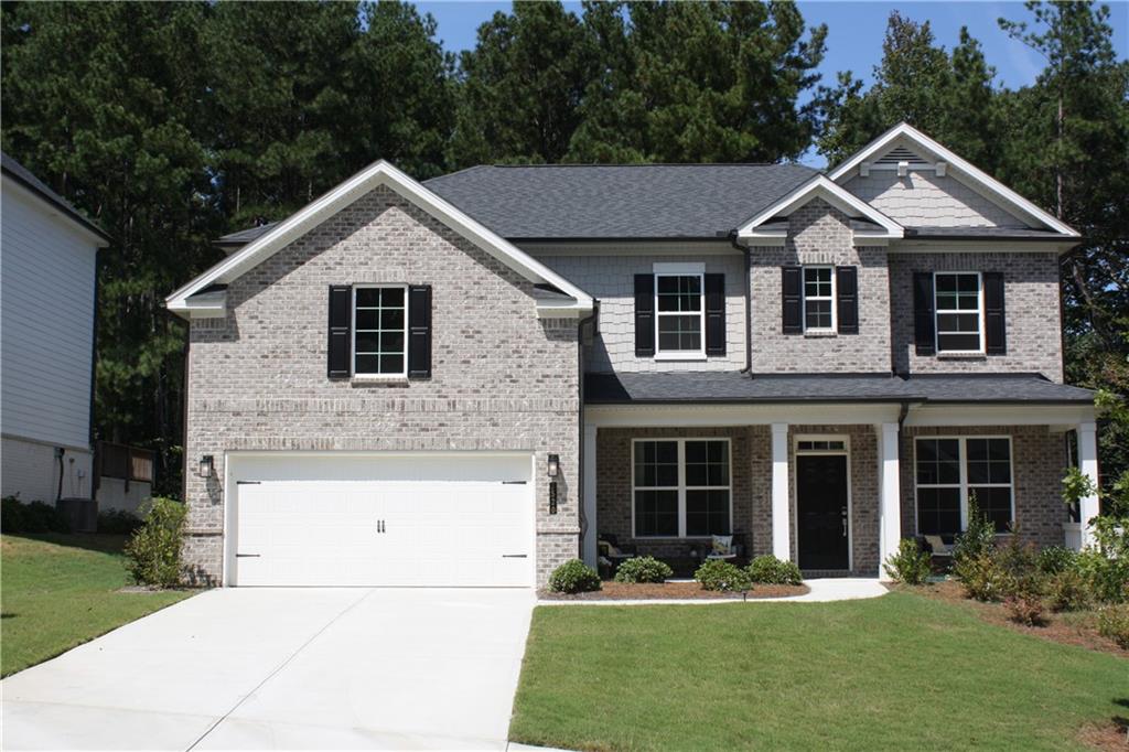 This beautiful almost new home has a fantastic floorplan. You enter the home into a 2 story foyer with a living room/office with French doors on the left and a formal dining room on the right. The formal dining room has an attached Butler Pantry and walks through to the amazing kitchen. The kitchen has a huge island,abundant cabinets,walk in pantry, double ovens,gas cooktop,external exhaust,large breakfast/dining area and is open to the attached great room.The great room has an electric ignition gas log fireplace and walks out to a covered patio.A fantastic and unique feature for this home is the extra room beyond the great room. This is a small room that could be an office,play room, etc. There is a first floor bedroom with a walk in closet which attach's to a full bathroom. Directly inside the home from the garage is a mud area to change shoes etc. The two car attached garage is level with the first floor. The second level has a large loft that provides a a perfect gathering area. The master is on this level with it's oversized closet, his/hers sinks,glass enclosed shower,soaking tub,private water closet,and generous sized bedroom.There are Jack and Jill bedrooms with their own bath and closets. The fourth upstairs bedroom has it's own private bathroom and walk in closet.The laundry room is on this level. It offers generous space for not only the washer and dryer but for ironing,laundy hampers,etc.The nice level lot,covered patio,2 car attached garage,etc. contribute to a high quality of living. The property is is located in a superb school district and is in close proximity to restaurants,shopping,and major roads including I-85.