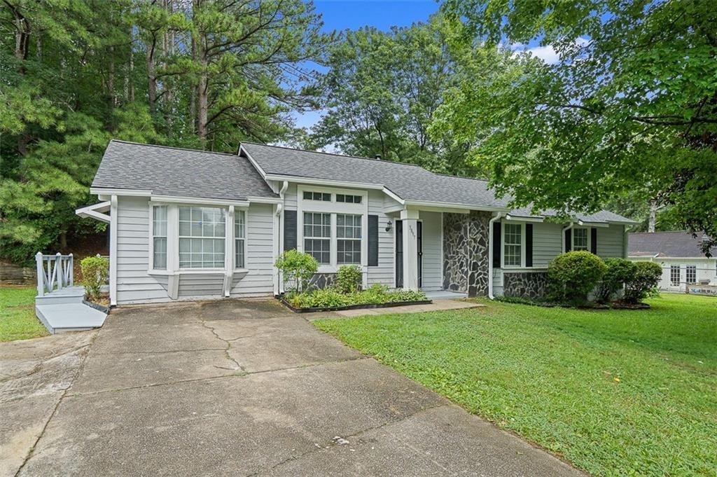 4.75% Interest Rate for a limited time! Or receive $9500 in closing costs! Welcome Home ATL to this charming 3-bedroom, 2-bath ranch nestled in a quiet, well-loved neighborhood. The open floor plan flows effortlessly from the great room to the dining area, while a separate living room adds extra flexibility for work or relaxation.The kitchen shines with granite countertops, tile flooring, white cabinetry, and stainless steel appliances. Both bathrooms are updated with matching tile and granite finishes, offering a clean and cohesive look. Out back, enjoy a spacious yard and large storage shed—perfect for weekend projects or extra storage. With a layout built for everyday living and a location close to schools, parks, and shopping, this one is not to be missed!