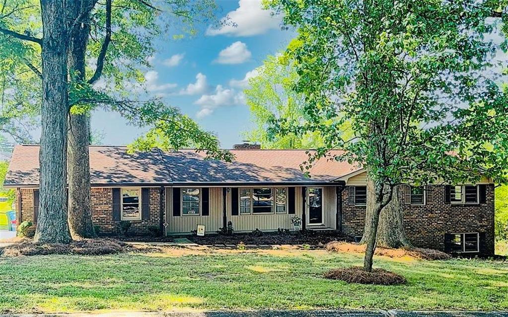 PRICED BELOW APPRAISED VALUE! Vintage Charm with Endless Possibilities in the Heart of Snellville. Welcome to your beautifully maintained all-brick ranch on a basement nestled on a spacious property in Snellville offering the perfect blend of comfort, charm, and opportunity! This classic 1969 home showcases over 1,900 square feet of living space, featuring 3 spacious bedrooms, 2 full bathrooms, a beautiful full length window sunroom and a partial basement with its own inside/outside entrance, ideal for a workshop, hobby space, or additional storage. Step inside to find freshly resurfaced original hardwood floors that add warmth and timeless character to every room. With a roof just 3 years old, plenty of storage, and a peaceful, friendly neighborhood setting, this home checks all the boxes and is MOVE-IN READY! Located in the heart of Snellville, you'll enjoy the perfect mix of city convenience and quiet suburban living. Just minutes from The Shoppes at Webb Gin, Lenora Park, Snellville Farmers Market, and Eastside Medical Center, plus easy access to dining of all types, entertainment, and top-rated schools. But wait, THERE'S MORE! This property includes an EXTRA BUILDING LOT, giving you INCREDIBLE OPTIONS! You could... (a) Build a second home (b) Expand your backyard for a pool, garden, play area OR (c) Sell the lot for extra cash! Whether you're dreaming of expanding, investing, or simply enjoying a solid, stylish home with space to grow, this is a RARE FIND you don't want to miss! Come see the potential. Fall in love with the charm. Make it yours.