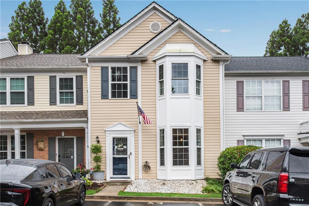 This beautifully maintained 2-bedroom, 2.5-bath townhome is perfectly situated in the heart of Alpharetta just 2 miles from Avalon, minutes to North Point Mall and downtown Alpharetta, and with quick access to GA-400 for easy commuting. Inside, you'll love the open floor plan featuring rich luxury vinyl flooring on the main level, fresh interior paint, and elegant plantation shutters throughout. The spacious family room is anchored by a striking stone fireplace and opens to a fully updated kitchen with granite countertops, stainless steel appliances, tile backsplash, and extensive molding details. A stylishly renovated half-bath on the main level is perfect for guests. Upstairs, you'll find two large bedrooms, each with its own updated en-suite bathroom. The primary bedroom features smart lighting compatible with Alexa for added convenience. Bay windows on both levels fill the home with natural light, while a beautiful wrought iron bannister adds a sophisticated touch. Step outside to your private backyard retreat, complete with a wood privacy fence, glass/screen storm door, and artificial turf for year-round, low-maintenance beauty. Additional upgrades include a newer roof (approximately 5 years old), new windows, water filtration system and a brand-new HVAC system, giving you peace of mind and energy efficiency. The neighborhood also offers a sparkling community pool for relaxation and recreation. Move-in ready and loaded with thoughtful updates, this townhome offers the perfect blend of comfort, style, and unbeatable location. (Pictures will be uploaded on Wednesday). Home is a "10".