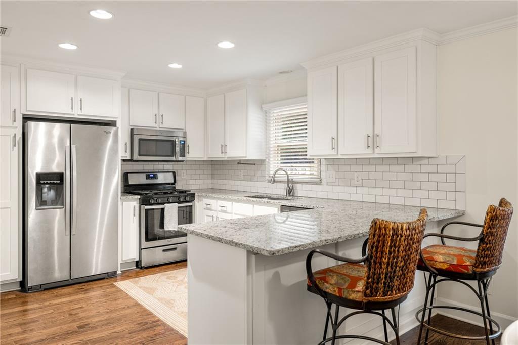 Tucked into the heart of Morningside Place, this classic brick townhome pairs timeless charm with everyday comfort in one of Atlanta’s most loved neighborhoods. Inside, natural light fills the open main living space, where the living room flows seamlessly into the dining area and kitchen. Whether you're hosting friends or enjoying a quiet night in, this layout makes it all feel easy. The kitchen is outfitted with white cabinetry, granite countertops, stainless steel appliances, a tile backsplash, and plenty of storage. Step outside to your private, fenced patio with space to garden, grill, or dine under the stars. Upstairs, the primary suite offers a peaceful retreat with a large walk-in closet and private bath. Two additional bedrooms and a full hall bath provide the flexibility to host guests, work from home, or grow into the space. The finished basement brings even more options, with room for a home gym, den, playroom, or creative studio. You’ll also have interior access to the one-car garage for easy parking and storage. This well-maintained home features a new HVAC, new water heater, and a newer roof that’s covered by the HOA. Live steps from Morningside Nature Preserve featuring scenic trails, a swing bridge, and the city’s favorite “dog beach,” along with the best dining and shopping in Morningside and Virginia Highland. Zoned for Morningside Elementary, this one truly checks all the boxes.