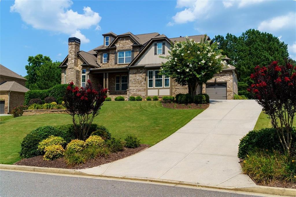 4-sided brick estate home featuring 6 bedrooms and 5.5 bathrooms on full, finished basement. The covered front porch welcomes you into the well lit spacious dining room with coffered ceiling and wainscoting, offering hardwood flooring situated across from the vaulted office with door featuring a stone fireplace. Two story foyer with wainscoting and a wrought iron spindled staircase. Spacious eat in kitchen with large sit at breakfast bar with granite countertops, Travertine tile backsplash, abundant dark stained cabinetry, stainless steel vent hood, pot filler, gas cooktop, built-in microwave and dishwasher all open to the keeping room with stone fireplace and great room. Spacious walk-in pantry and mudroom station. Spacious bedroom on the main level with sitting room with built-in bookcase cabinetry and full bathroom. Butler's pantry with wine refrigerator. Large primary bedroom upstairs with trey ceiling with ceiling fan and sitting room. Spacious vaulted primary bathroom with double granite countertop vanities, tile flooring, soaking tub, spacious walk-in Travertine tile shower and large walk-in closet. Secondary bedrooms with jack and jill bathroom. Media room and craft room/bedroom suite with full bathroom upstairs along with the spacious laundry room with built-in cabinetry. Full, finished walk out basement with recreation room, Billard room, workout room, full bathroom, sauna and storage room. Do not miss the spacious deck overlooking the inviting pool and beautiful backyard.