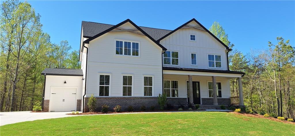 The Hammond Plan built by Peachtree Residential. Fabulous Basement Home with Exceptional Outdoor Living and 3-Car Garage! This beautifully designed home offers everything today's buyer is looking for including a guest suite on the main level, open-concept living, and incredible outdoor spaces. A charming front porch welcomes you inside, where 10-foot ceilings and a soaring great room create an open, airy feel. The gourmet kitchen features a large island, walk-in pantry, double ovens, and opens seamlessly to the sunny breakfast area, fireside great room, and screened porch with an outdoor fireplace ideal for entertaining or relaxing. Guests will love the private first-floor bedroom retreat, while a convenient home office completes the main level. Upstairs, the spacious owner's suite includes a spa-inspired bath and oversized walk-in closet. Three additional bedrooms and a generous bonus room provide plenty of space for family or play. The side-entry 2-car garage is complemented by a separate 1-car garage perfect for a third vehicle, golf cart, or workshop. The full daylight basement is stubbed and ready to finish, offering even more potential living space. The level backyard backs up to a serene wooded area, providing peace and privacy. Located in a desirable lakeside community just moments from Tidwell Park with boat ramp and beach access this is lake living at its finest!