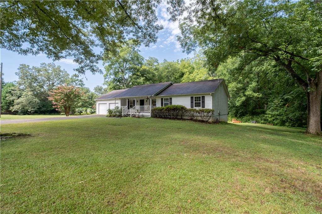 Well-Maintained Ranch House with Rocking Chair Front Porch on 3.7 Acres. Nestled in prime West Cobb real estate, this well-maintained ranch-style home exudes charm. Picture yourself on the rocking chair front porch, savoring morning coffee or watching the sunset. Inside, you’ll find 3 bedrooms, 2 baths, and an unfinished basement—a canvas for your creativity. Whether you choose to live in it as-is, renovate, or build your dream home, the 3.7-acre lot offers endless possibilities. Conveniently located near the West Cobb Avenues, this property provides easy access to restaurants, shopping, parks, and excellent schools. Enjoy, quick connectivity to downtown Marietta, Kennesaw Mountain, Kennesaw State University, and I-75. Don’t miss out—schedule your viewing today!