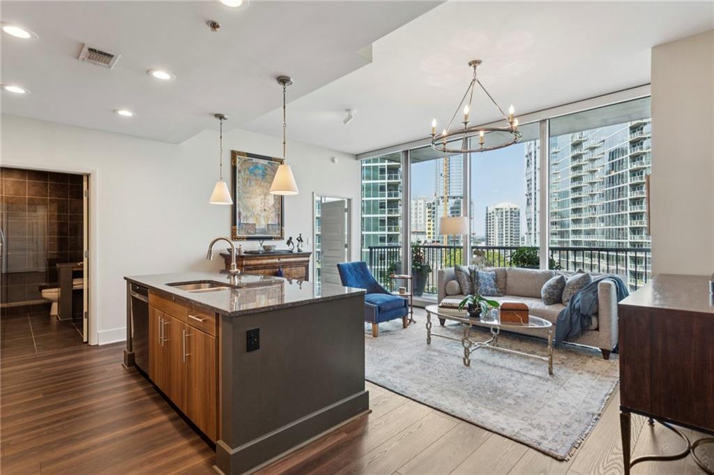 Perfect luxury Midtown Flat with breathtaking views that include wonderful sunsets! Walls of windows open to your massive balcony overlooking the heart of Atlanta. An open chef's kitchen and large living area make this the perfect home for entertaining. Upgrades include new hardwoods throughout and new HVAC. Amenities include resort-style pool, state of the art gym (complete with Peloton) newly renovated clubroom (and fun social events with neighbors), and outdoor grilling area. Two deeded parking spaces in the secure parking deck. This unit also comes with a large storage unit (6.6ft x8ft). Walk to all things Midtown -- Whole Foods, Publix, Savvi gourmet market as well as Publix. And ten minutes to Piedmont Park! Also nearby are High Museum, and Fox Theater. So many restaurants nearby including all the wonderful options at Colony Square.
