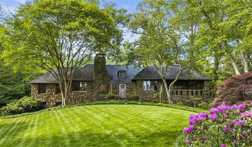 This special home has been the subject of multiple advertising campaigns and the site of 3 Botanical Garden Tours. It truly is a landmark home for Historic Brookhaven with one of the best views overlooking Capital City Golf Course. It is impossible to describe the charm of the living area. These sellers have invested over 50 years of love into this home and when you sit in the Norman Askins designed huge garden room addition with its intricate ceiling and view of both the golf course and the gardens, you know why they love it. It is situated on a double lot with spectacular backyard gardens complete with a delightful garden house and water features. There is plenty of room to expand the home if so desired. There is a main-level master bedroom with his and hers baths. A second main level bedroom is currently furnished and used as a sitting room.
