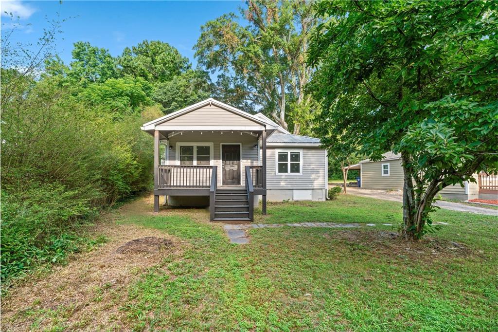 Cute, cozy, and close to everything! This updated bungalow sits just off downtown Winder, practically across the street from the newly revamped Fort Yargo State Park, and just a quick hop from the Exchange shopping district off Hwy 316. Even better? You're only about 30 minutes from Athens Go Dawgs! Step inside to find all new windows, sleek stainless steel appliances (just 3 years young), fresh white shaker cabinets, and gray laminate flooring that flows through the living room and kitchen. The gray carpeted bedrooms keep things comfy, while the WiFi-enabled thermostat adds a touch of smart-home convenience. This 2-bedroom, 2-bath home also offers a bonus flex space perfect for a third bedroom, home office, or playroom (your call!). Outside, the metal roof adds character, and though there's a shared driveway, you've got a 2-3 car parking pad tucked around back for plenty of space. Looking for easy living in a location that puts parks, shops, and downtown just minutes away? You've found it. Come check it out this one's got personality!